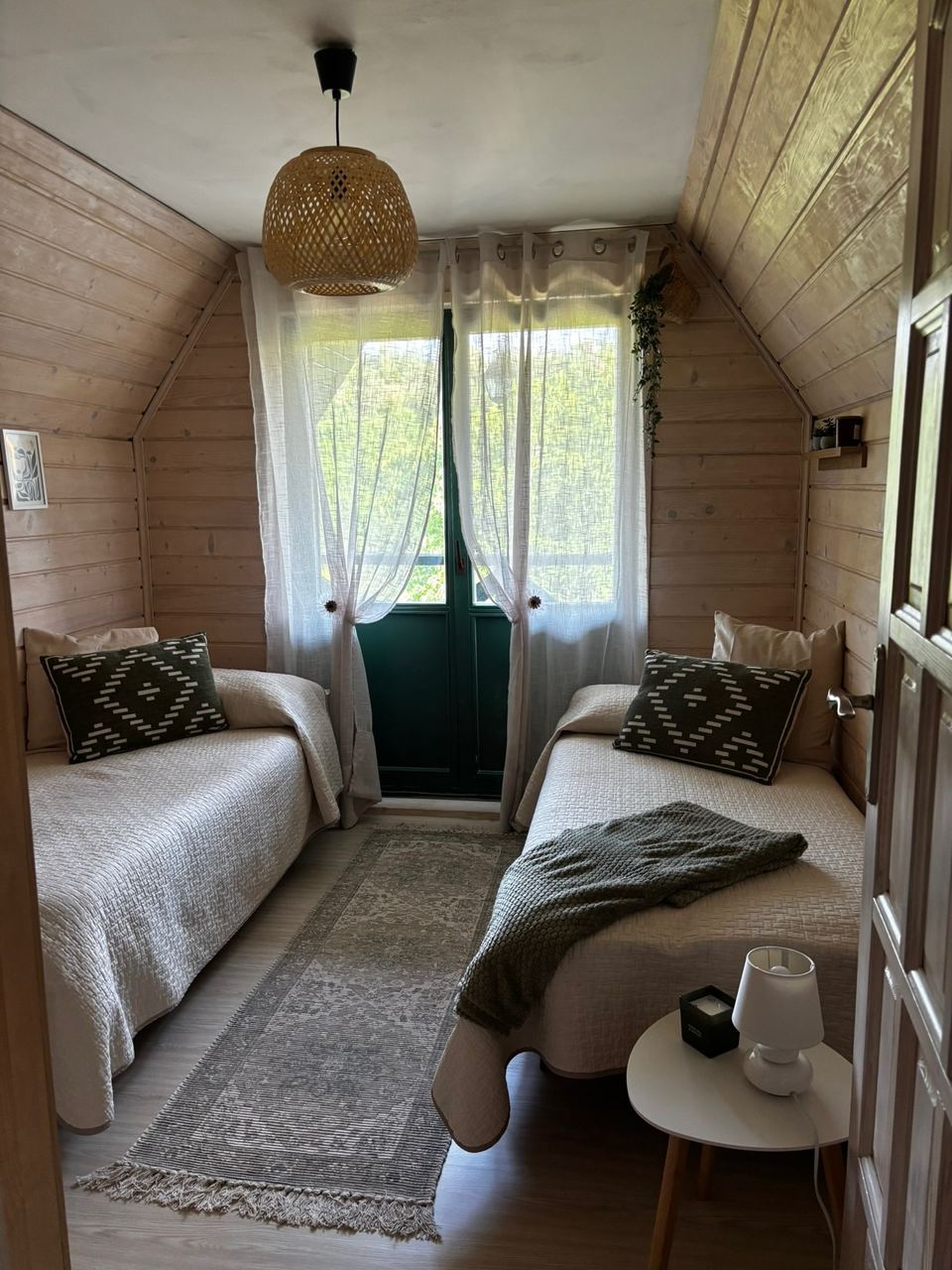 Wooden twin room with two single beds and French window