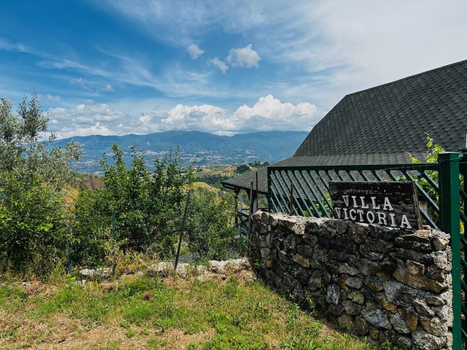 Villa Victoria entrance with stone wall and sign
